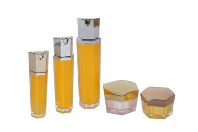 China Hexagon Gold/Yellow Beauty Packaging Acrylic 30/60/100ml Moisturizing Lotion Bottles And 30/50g Cream Jar for sale