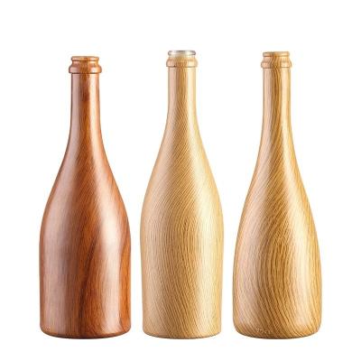 China Custom Size Accepted 750ml/350ml Wooden Pattern Glass Bottle for Beer Water Champagne for sale