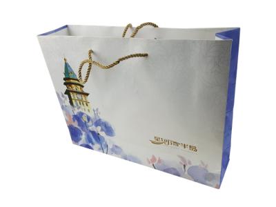 China Gift Packaging Paper Bags Customized Size Cardboard Material CMYK Color Printing with Gold Color Rope Handle for sale