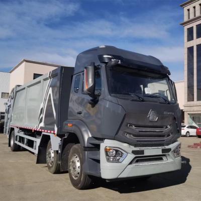 中国 Sinotruk HOWOの廃物のコンパクターのトラック6x4 24m3のごみ収集車の価格 販売のため