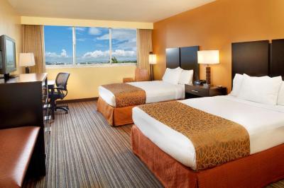 China Jogja hotel interior design of guestroom furniture wood panel headboard and Drawer of TV cabinet with leisure chair for sale