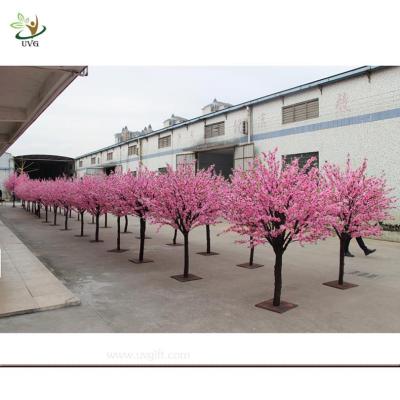 China UVG artificial pink flowering cherry tree in wooden trunk for exhibition hall decoration CHR035 for sale