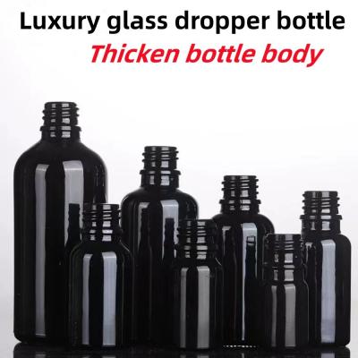 China Black 10, Ml 15ml 20ml 30ml 50ml empty round black shiny Glass Essential Oil Dropper Bottle with Plastic Gold ring for sale