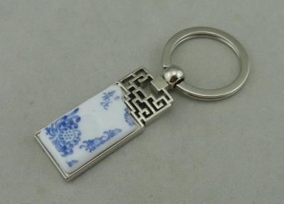 China 1.5 Inch Zinc Alloy Advertising Keychains With Porcelain Piece Inserted for sale