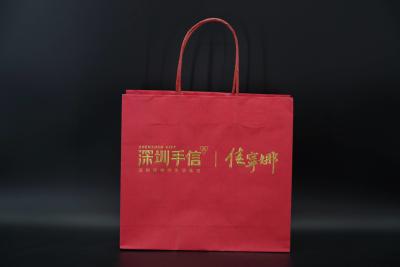 China recycled Eco Paper Bags Hot Stamping Red Kraft Bags With Handles Twisted for sale