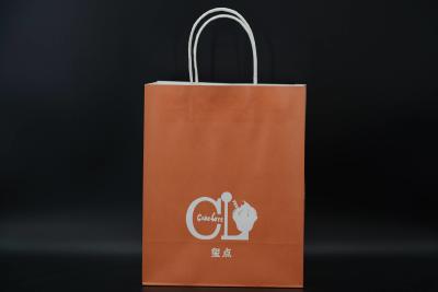 China Custom Orange Eco Paper Bags With Handles Twisted Solid Plate Printing for sale