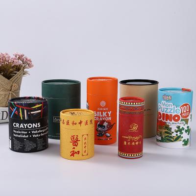 中国 ODMのプラスチック食糧缶は円形シリンダー箱のクラフトのボール紙の包装の上で押す 販売のため