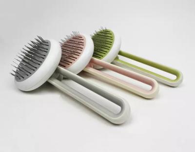 China Sustainable Pet Grooming Brush Self Cleaning Dog Pet Hair Remover Cat Comb With Massaging Bead On Tips à venda