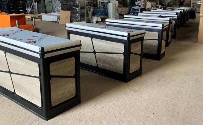 Stainless steel supermarket checkout counter side view