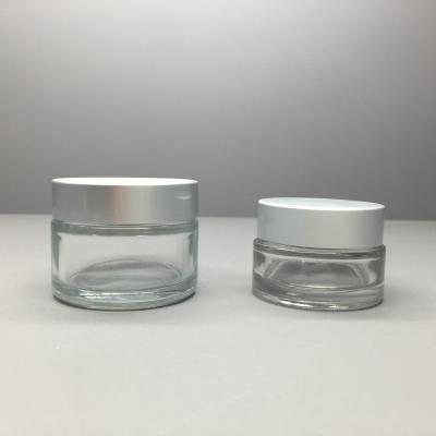 China 50g 20g Cosmetic Packaging Clear Glass Cream Jar With Aluminum Cap for sale