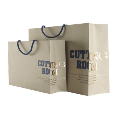 China Custom Recycled Brown Paper Merchandise Bags Wholesale With Gold Foil Logo for sale