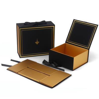 China Custom Logo Print Paper Cardboard Foldable Magnetic Shopping Gift Box With Ribbon for sale