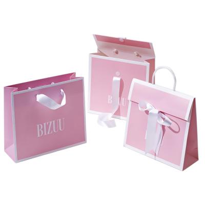 China Bolso de envío de empaquetado de imprenta del papel del boutique del regalo de las compras populares rosadas de encargo del bolso para la ropa de la ropa en venta