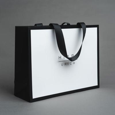 China Saco de compras de empacotamento de papel feito sob encomenda luxuoso com logotipo à venda