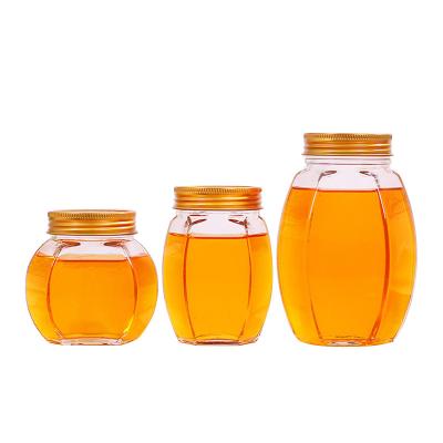 China Metal Lid Glass Honey Jar Hexagon Shape Recyclable Food Storage Container for sale
