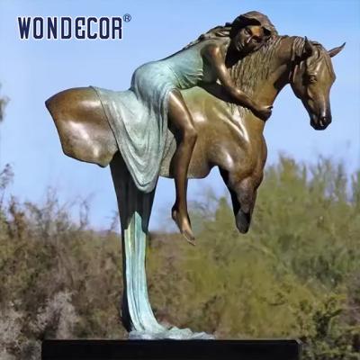 中国 A Copper Sculpture Of A Young Girl On A Large Metal Art Horse Back Outdoors 販売のため