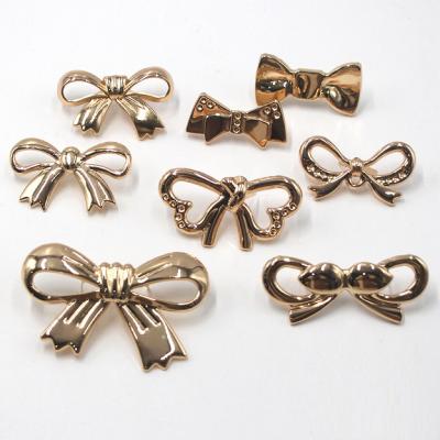 China ODM Handbag Metal Tags Durable Embossed Brass Antirust Bow Knot Shape Purse Label for sale