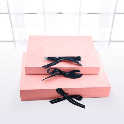 China Book Shape Debossing Magnetic Garment Packaging Boxes With Ribbon for sale