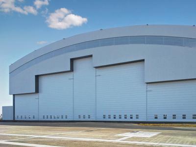 China Prefab Curve Roofing System Steel Aircraft Hangars With Electrical Slide Doors for sale