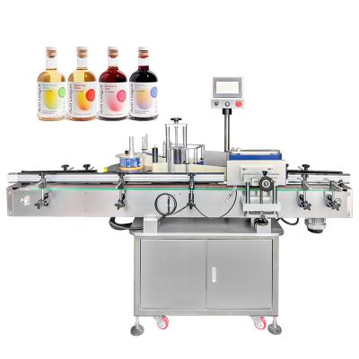 China Volledig automatische high speed sap drank fruit azijn glas wrap rond label applicator ronde fles etikettering machine Te koop