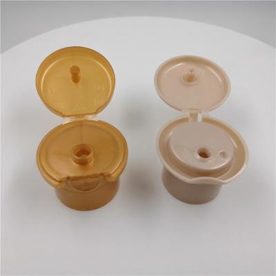 China Various Volume Cosmetic 28mm Plastic Bottle Flip Top Cap Round Shape for sale
