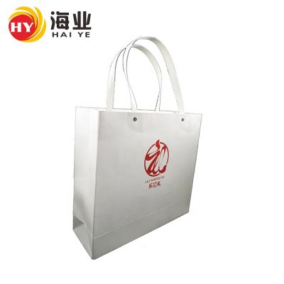 China Custom Logo Craft Paper Bag White Gift Packaging Bag Recyclable Shopping Bag With Snap Button Flat Handle for sale