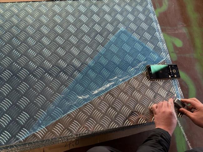 Close-up view of aluminum checkered plate diamond pattern