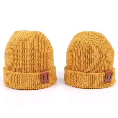 China Leather Patch Knit Beanie Hats Custom Design Warm Hat Cap Yellow Beanie Hats for sale