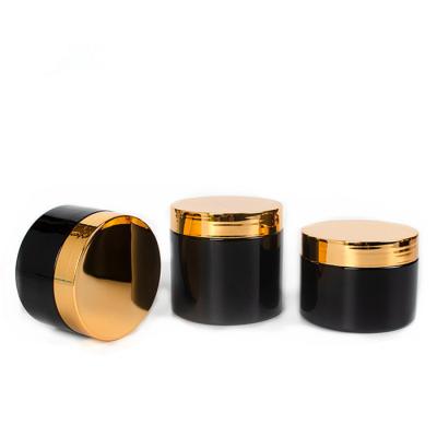 China Wide Mouth PET Round Plastic Canisters 100ml Black Cosmetic Jars With Gold Lid for sale