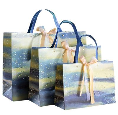 China Odm Oil Hand Painted Clothes Shopping Bag Art Style Kraft Paper Bag 157gsm for sale