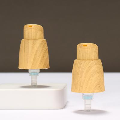 Chine Pompes à lotion en plastique sans air à ressort externe 0,25 cc Pompes à lotion pour les mains avec grain de bois à vendre