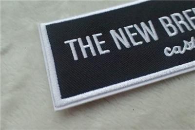 China Washable Black Polyester Custom Clothing Patches / Adhesive Embroidered Patches for sale