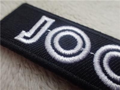China Black Twill White Line Custom Embroidered Patches With Stylish Backing Hot Melt Adhesive for sale