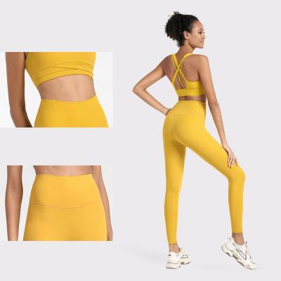 China Solid Color Women's 2 Piece Yoga Set Sexy Cross Back Bra Sports Clothes Yoga Leggings for sale