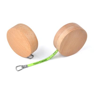 Китай Wintape Custom Round Wooden Mini Steel Tape Measure Stand Out From The Crowd 1m 3ft Fluorescent Green blade measurement продается