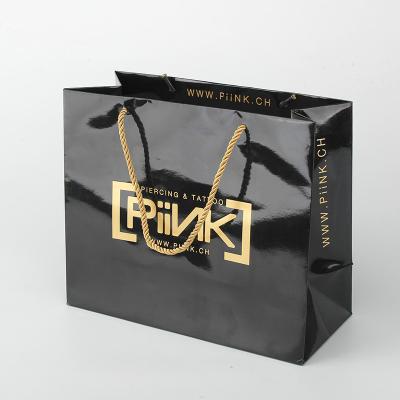 China Shiny Paper Shopping Bag Promotional Black Customize Paper Bags With Gold Foil Logo for sale