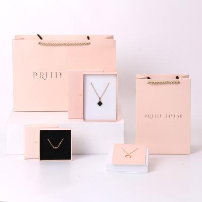 China Pink Jewelry Bag Paper Bag Manufacturer Pink Gift Bag With Gold Foil Logo for sale