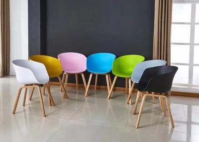 China Nordic Wooden Leg Plastic Chair PP Seat Plastic Dining Armchair for sale