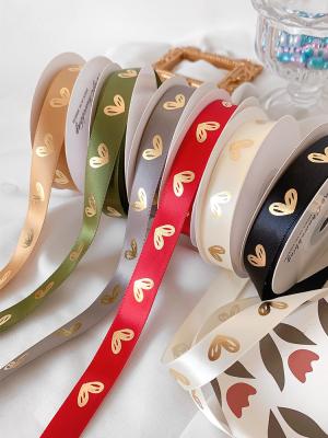 China 16mm Heart Pattern Gold Foil Printed Ribbon For Gift Packing And Decoration for sale