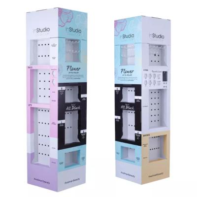 Chine Support d'affichage de papier fait sur commande de présentoir de carton de cosmétiques d'affichage de plancher de carton avec des crochets pour le maquillage à vendre
