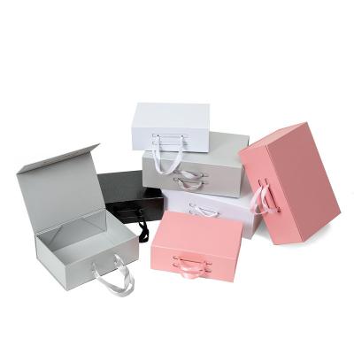 China CMYK Printing Collapsible Paperboard Magnetic Gift Box With Silk Ribbon for sale