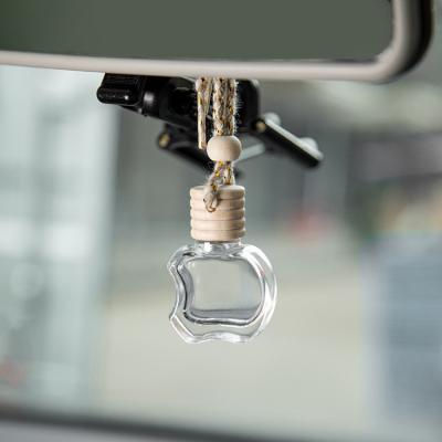 China Apple Shape Glass Car Perfume Bottles Essential Oil Diffuser Aromatherapy Car Air Fresher With Wire for sale
