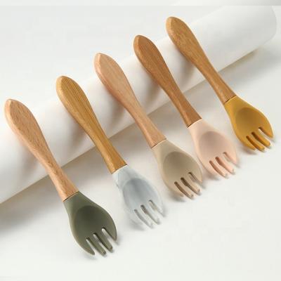 China Food Grade Silicone Forks And Spoons Heat Resistant With Wooden Handle for sale
