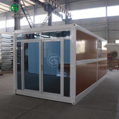 中国 Windproof And Warm 20ft Fold Out Container Homes Wood Grain Glass Manufacturer 販売のため