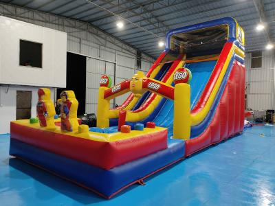 China Fireproof 0.55mm PVC Tarpaulin Giant Inflatable Dry Slide Inflatable Castle LEGO Theme For Kids And Adults for sale