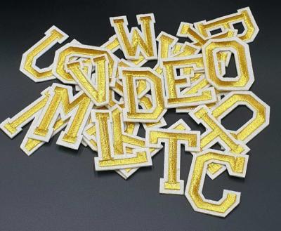 China Gold Embroidered Letter Appliques Heat Cut Border Embroidered Alphabet Patches for sale