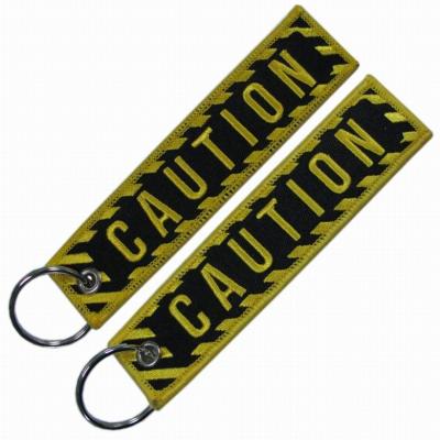 China Promotional Gifts Custom Cheap Jet Tag Fabric Embroidery Car Keychains Woven Keychain for sale