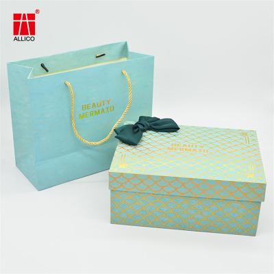 China Custom Design Ribbon Handle Blue Jewelry Cosmetic Gift Clothing Shopping Packaging Bag for sale