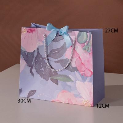 China Red Art Paper Printed Paper Shopping Bag With Ribbon Handle for sale