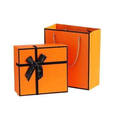 China Orange Cosmetic Paper Box Makeup Sets Ribbon Cosmetic Packaging Box for sale